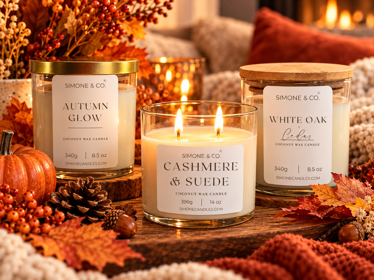 Three candles with fall scenery in the background 